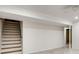 Basement with stairs and an open area; white walls, ceiling, and tile flooring at 3916 Green Forest Se Ln, Smyrna, GA 30082