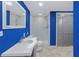 Upgraded bathroom has vibrant blue walls, sleek vanity, and tiled shower for a luxurious feel at 3916 Green Forest Se Ln, Smyrna, GA 30082