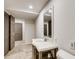 Bathroom vanity with a marble top, sink, and a mirror, near the toilet at 3916 Green Forest Se Ln, Smyrna, GA 30082