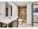 Bathroom featuring tiled shower, vanity with sink, toilet and tiled flooring at 3916 Green Forest Se Ln, Smyrna, GA 30082