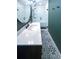 Modern bathroom featuring a new vanity with quartz countertop, decorative floor, and a glass-enclosed shower at 3916 Green Forest Se Ln, Smyrna, GA 30082