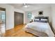 Comfortable bedroom bathed in natural light features hardwood floors and ample closet space at 3916 Green Forest Se Ln, Smyrna, GA 30082