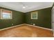 Bedroom with hardwood floors, modern ceiling fan, and two windows for natural light at 3916 Green Forest Se Ln, Smyrna, GA 30082