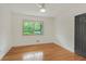 A bright, airy bedroom with hardwood floors and a large window allowing plenty of natural light at 3916 Green Forest Se Ln, Smyrna, GA 30082