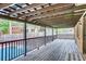 Spacious covered deck with dark wood planking overlooks a sparkling pool with a secure railing at 3916 Green Forest Se Ln, Smyrna, GA 30082