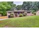 Charming brick home with a well-maintained front yard and mature trees at 3916 Green Forest Se Ln, Smyrna, GA 30082