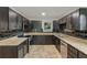Modern kitchen with dark cabinetry, granite countertops, and stainless steel appliances at 3916 Green Forest Se Ln, Smyrna, GA 30082