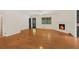 Open-concept living area featuring a fireplace and gleaming hardwood floors at 3916 Green Forest Se Ln, Smyrna, GA 30082