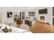 Bright living room with wood floors, fireplace, sofa, and window overlooking greenery at 3916 Green Forest Se Ln, Smyrna, GA 30082