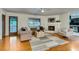 Sunlit living room with hardwood floors, a fireplace, and neutral decor at 3916 Green Forest Se Ln, Smyrna, GA 30082
