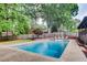 Backyard pool offers a refreshing oasis with mature trees and landscaping for added privacy at 3916 Green Forest Se Ln, Smyrna, GA 30082