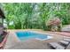Inviting in-ground pool with mature trees, lounge chairs, and a privacy fence creating a backyard oasis at 3916 Green Forest Se Ln, Smyrna, GA 30082