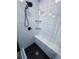 Sleek, tiled shower with built-in bench seating, rainfall shower head, glass shelving, and hexagon tile flooring at 3916 Green Forest Se Ln, Smyrna, GA 30082