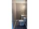 Neutral powder room featuring wood-look flooring, small vanity, and towel bar at 615 Waynes Se Ct, Atlanta, GA 30354