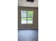 Bright bedroom featuring a window and neutral walls paired with dark hardwood floors at 615 Waynes Se Ct, Atlanta, GA 30354