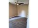 Bedroom with a ceiling fan, neutral walls, and dark floors with light shining in from a window at 615 Waynes Se Ct, Atlanta, GA 30354