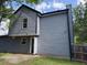 Rear exterior view of a two-story home with gray siding and a door at 615 Waynes Se Ct, Atlanta, GA 30354