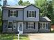Two-story home featuring a well-manicured lawn, gray siding, black shutters, and modern windows at 615 Waynes Se Ct, Atlanta, GA 30354