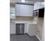 Clean kitchen showcasing white cabinets, stainless steel appliances, and wood-look flooring at 615 Waynes Se Ct, Atlanta, GA 30354
