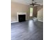 Living room featuring wood-look floors, neutral walls, fireplace, ceiling fan, and window views at 615 Waynes Se Ct, Atlanta, GA 30354