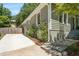View of side yard with landscaped garden and stone steps leading to the entrance at 1116 United Se Ave, Atlanta, GA 30316
