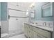 Modern bathroom offers a glass enclosed shower, double sinks, and subway tile at 1116 United Se Ave, Atlanta, GA 30316