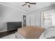 Neutral bedroom features a ceiling fan, ensuite bathroom, and dark wood floors at 1116 United Se Ave, Atlanta, GA 30316