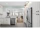 Stylish kitchen featuring stainless steel appliances, white cabinetry, and an open layout to the dining area at 1116 United Se Ave, Atlanta, GA 30316