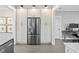 Well-lit kitchen with stainless steel refrigerator, white cabinets, tile flooring, and ample storage space at 1116 United Se Ave, Atlanta, GA 30316