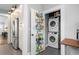 An efficient laundry area includes a stacked washer/dryer and ample storage on the pantry door at 1116 United Se Ave, Atlanta, GA 30316