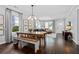 Open-concept living area featuring hardwood floors, decorative lighting, large windows, and comfortable seating at 1116 United Se Ave, Atlanta, GA 30316