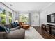 Bright living room featuring hardwood floors, large windows, and an open layout, ideal for entertaining and comfortable living at 1116 United Se Ave, Atlanta, GA 30316