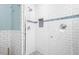 Close up of tiled shower with glass enclosure and mosaic tile accents at 1116 United Se Ave, Atlanta, GA 30316