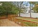 This home features a spacious back deck overlooking a backyard with new fence and mature trees at 1183 Mobile Nw St, Atlanta, GA 30314