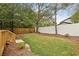 Lush backyard with wooden deck, tall privacy fence, and mature trees at 1183 Mobile Nw St, Atlanta, GA 30314