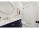 Modern bathroom with a navy vanity, gold fixtures, and a glass-enclosed shower at 1183 Mobile Nw St, Atlanta, GA 30314