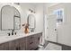 Modern bathroom with double vanity, quartz countertops, arched mirrors, and stylish fixtures at 1183 Mobile Nw St, Atlanta, GA 30314