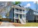Charming two-story home featuring a double front porch, steps to the entry, and beautiful landscaping at 1183 Mobile Nw St, Atlanta, GA 30314