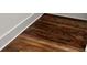Close-up of newly installed and stained hardwood flooring and white baseboards at 1183 Mobile Nw St, Atlanta, GA 30314