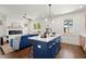 Modern kitchen features a center island with white countertops and seating area next to a spacious living room at 1183 Mobile Nw St, Atlanta, GA 30314