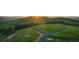 An aerial view highlights a vacant homesite with a paved road surrounded by beautiful greenery at 231 Laurel Vista Dr, Canton, GA 30114