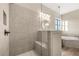 Walk-in shower with glass enclosure, gray tiled walls, built-in bench, and nearby soaking tub for a spa-like feel at 231 Laurel Vista Dr, Canton, GA 30114