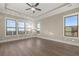 Sun-filled bedroom with hardwood floors, tray ceiling, and expansive windows offering stunning views at 231 Laurel Vista Dr, Canton, GA 30114