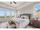 Light-filled bedroom featuring tray ceilings and outdoor views at 231 Laurel Vista Dr, Canton, GA 30114