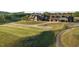 View of a community golf course and clubhouse with neatly manicured lawns and winding paths at 231 Laurel Vista Dr, Canton, GA 30114