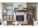 Living room with stone fireplace, decorative accessories, and cabinet at 231 Laurel Vista Dr, Canton, GA 30114
