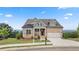 Charming two-story home with stone and siding, a well-manicured lawn, and an attached two-car garage at 231 Laurel Vista Dr, Canton, GA 30114