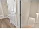 Hallway features a closet door, wood flooring, and a staircase descending to the basement at 231 Laurel Vista Dr, Canton, GA 30114