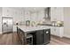 Open kitchen with a large center island, modern appliances, and sleek white cabinetry at 231 Laurel Vista Dr, Canton, GA 30114