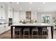 Kitchen with a center island with seating, elegant lighting, and stainless steel range hood at 231 Laurel Vista Dr, Canton, GA 30114